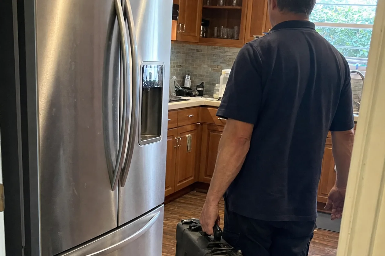 Wide mirrored view of a kitchen at the start of a service call, the equipment still in its case